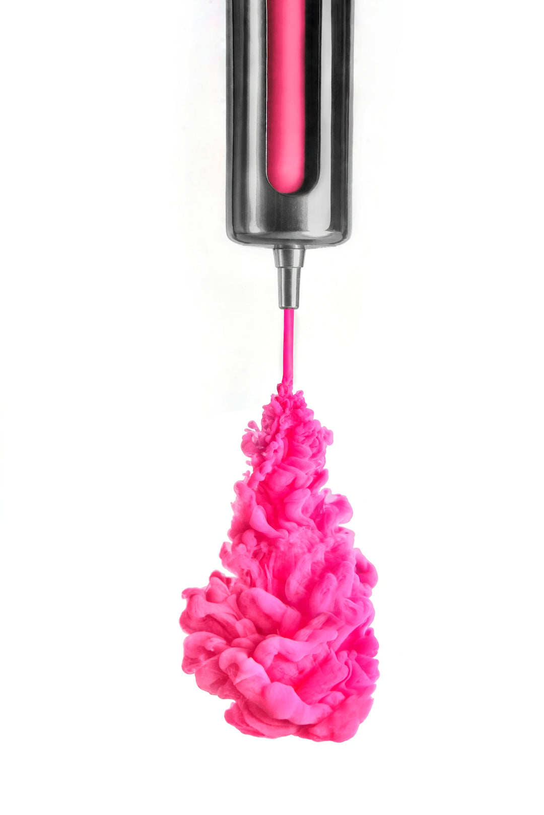 a pink substance is being dropped into a black container