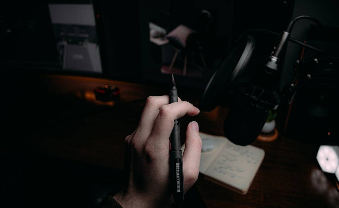 person holding black click pen