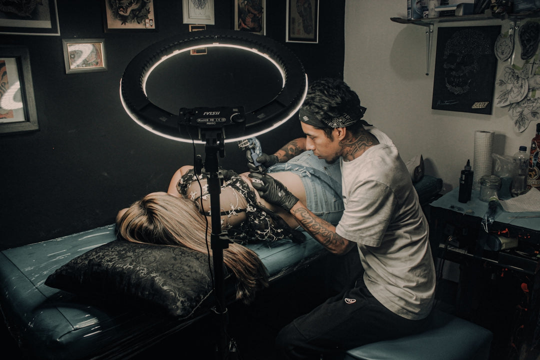 a man with a tattoo on his arm and a woman with a drum