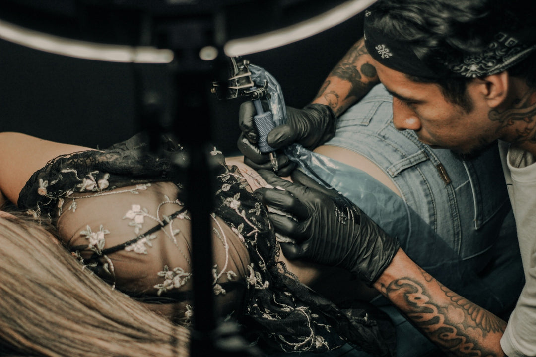 a man working on a tattoo