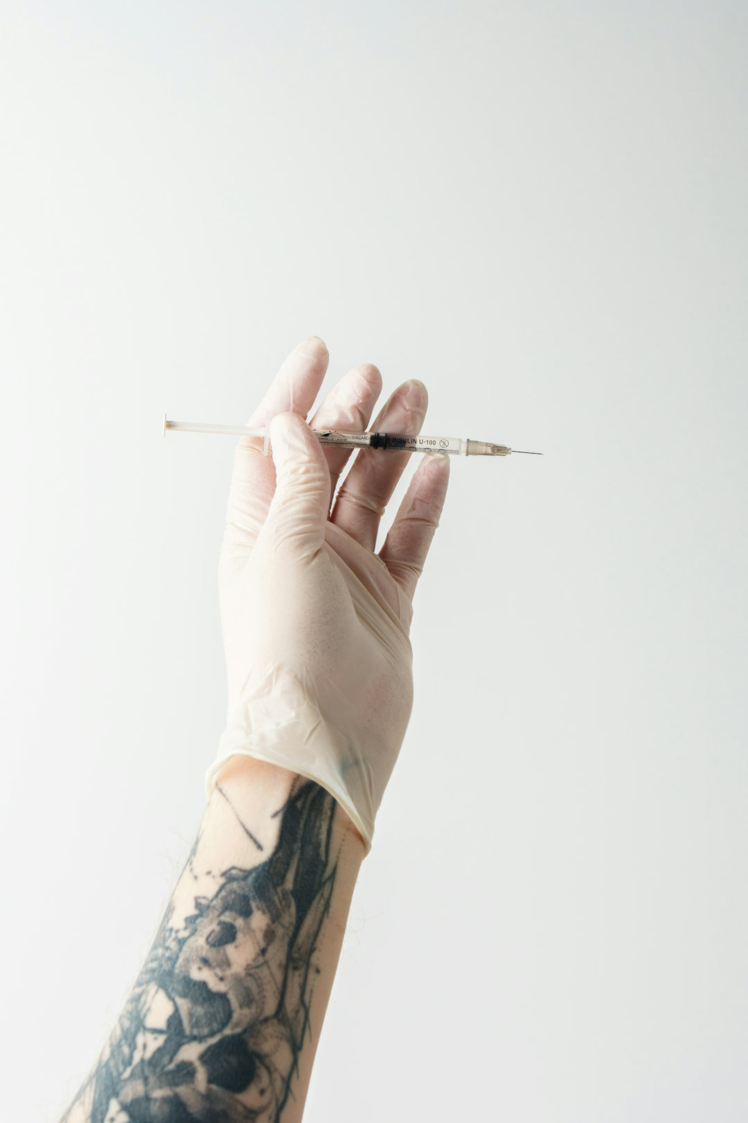 a hand holding a needle