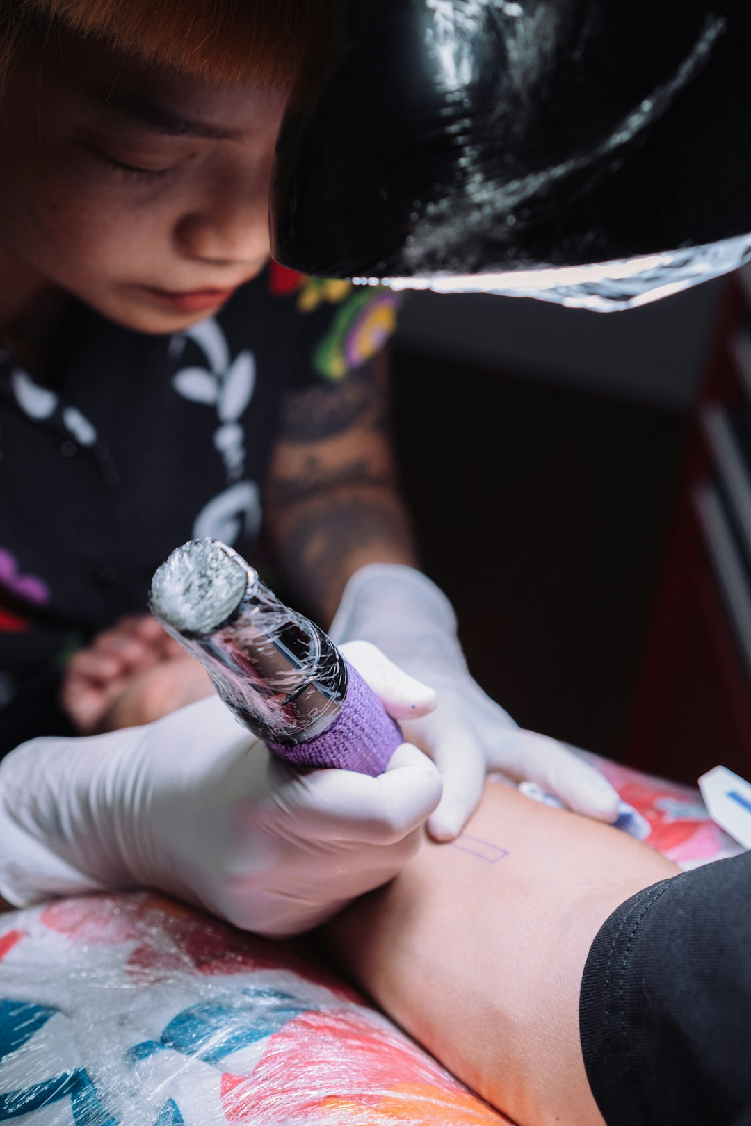 a person getting a tattoo on their arm