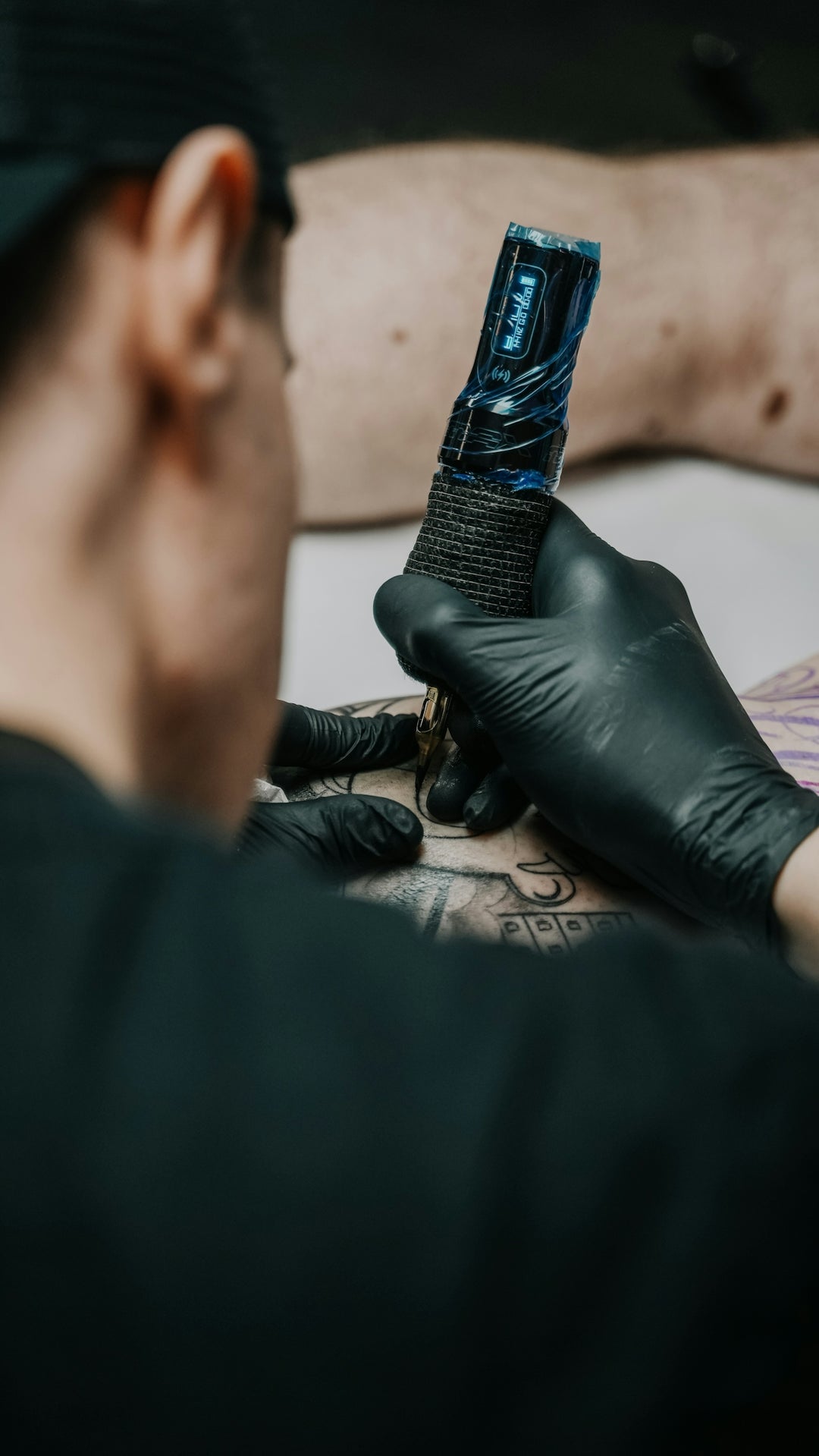 a man getting a tattoo on his arm