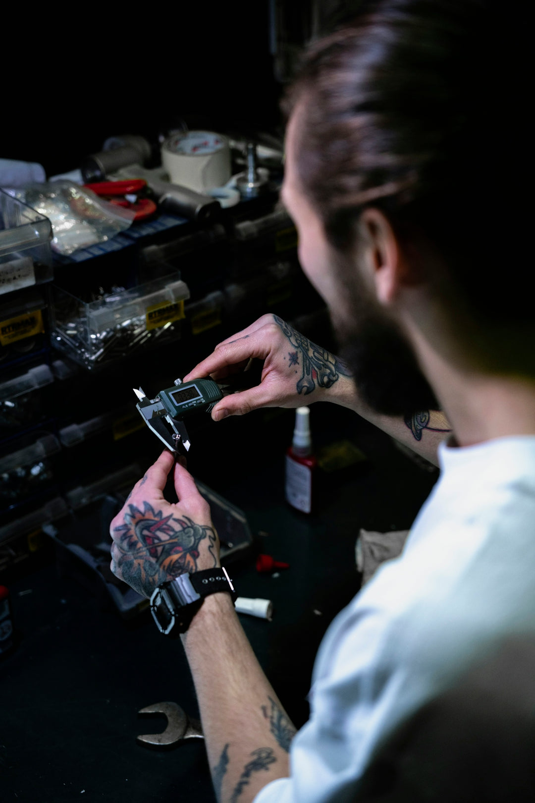 a man with a tattoo on his arm holding a cell phone
