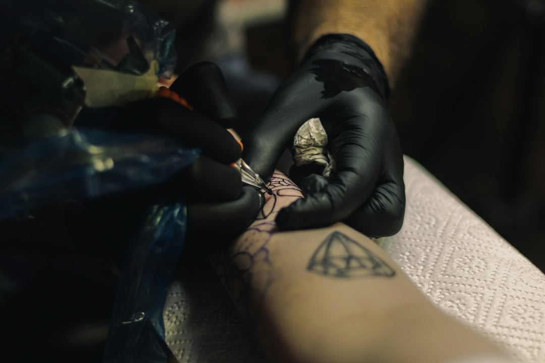 a person getting a tattoo on their arm