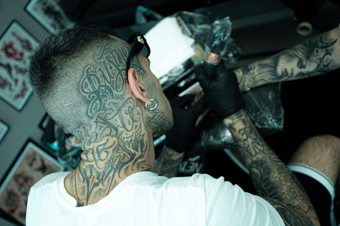 A man with lots of tattoos on his face