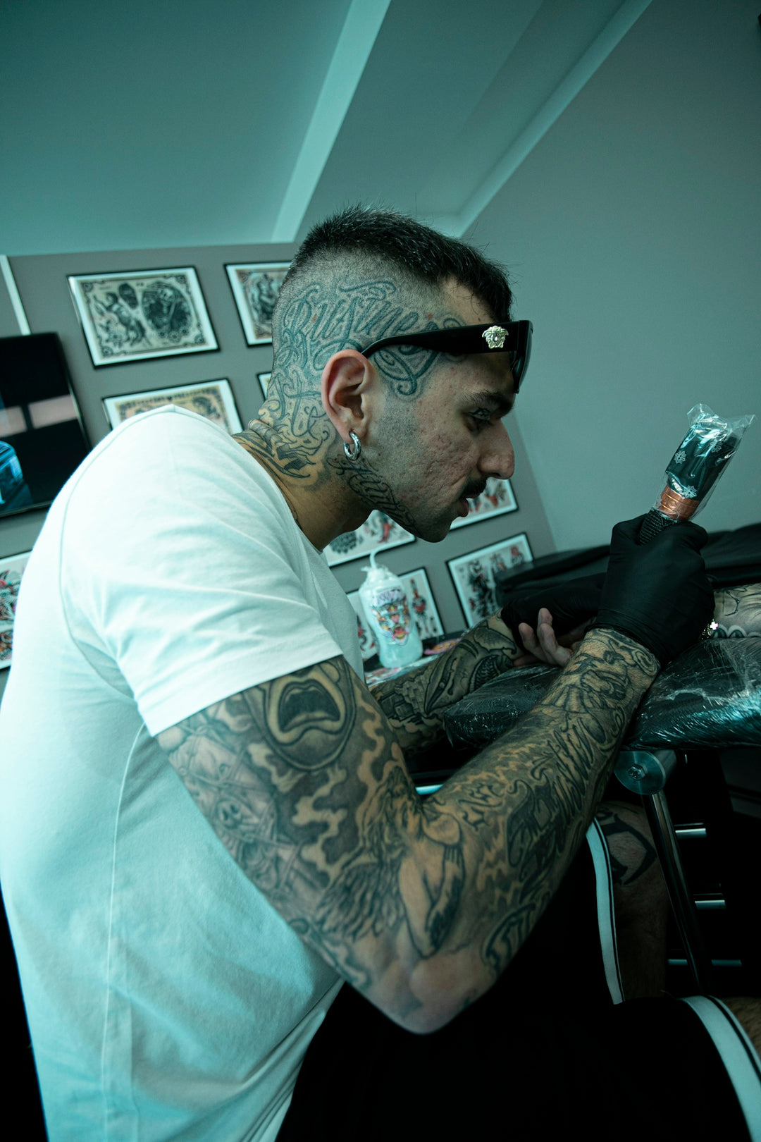 A man with tattoos sitting in a chair